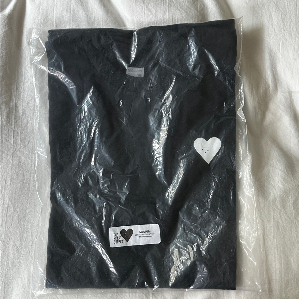 Black T-Shirt with Heart Design.The heart supply